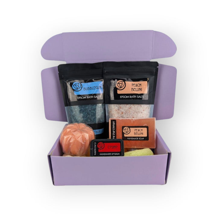 Glasgow Soap Company Ltd limited edition mystery box with bubblegum and peach bellini bath salts, handmade soap, lip balm, and bath accessory.