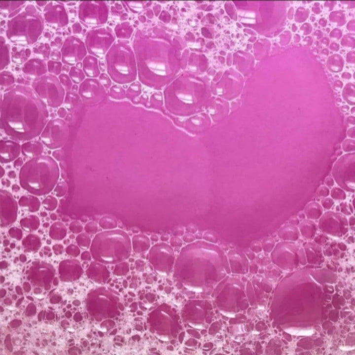 Glasgow Soap Company Ltd Parma Violet bath salts in pink bubbly water, 250g.
