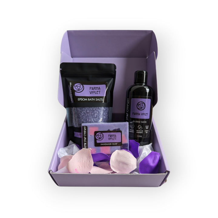 Glasgow Soap Company Parma Violet self-care bath set with Epsom salts, handmade soap, bubble bath, and petals.