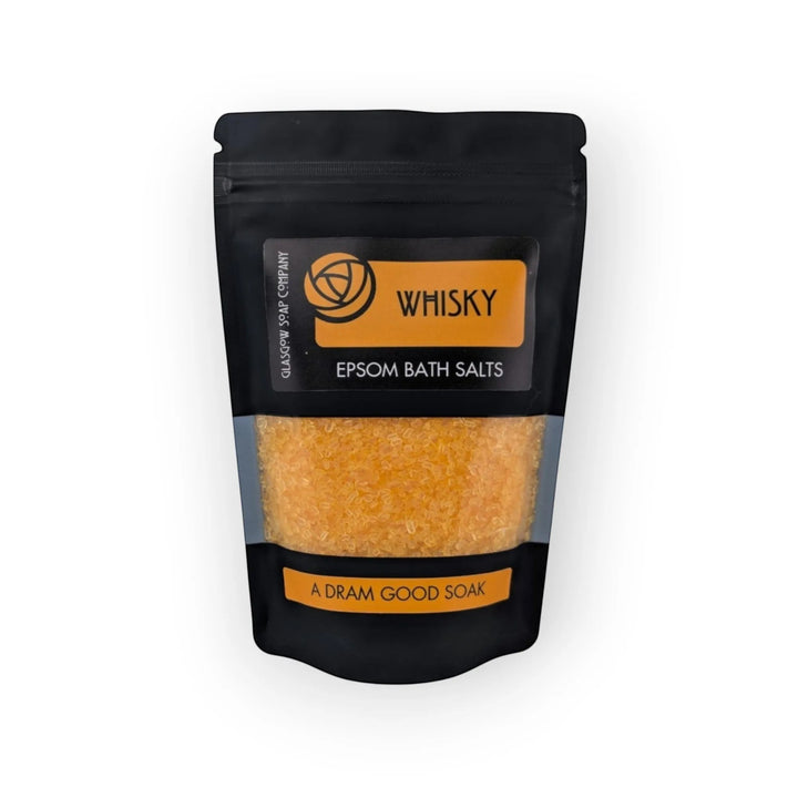 Glasgow Soap Company Ltd Whisky Epsom Bath Salts in a black pouch with a clear window showing orange salts.