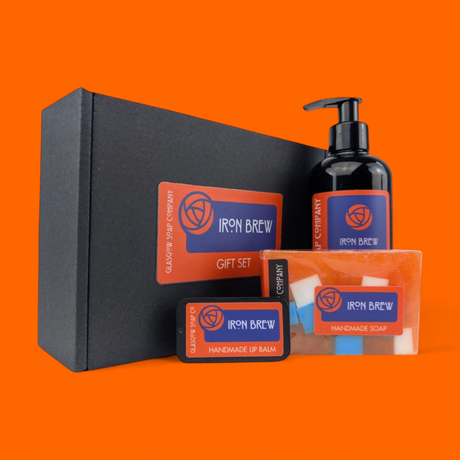 Iron Brew irn bru gift set with soap, liquid soap, and lip balm on an orange background