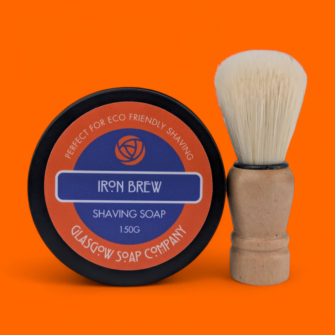 Shaving soap container and brush on an orange background