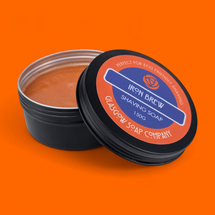 Shaving soap container with 'Iron Brew' label on an orange background