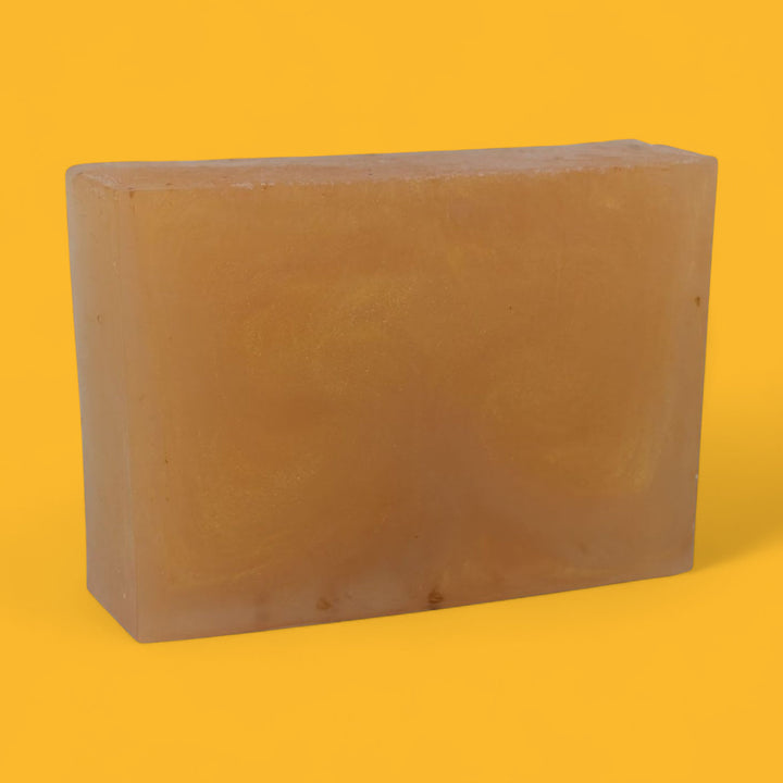 Rectangular brown bar of soap on a yellow background