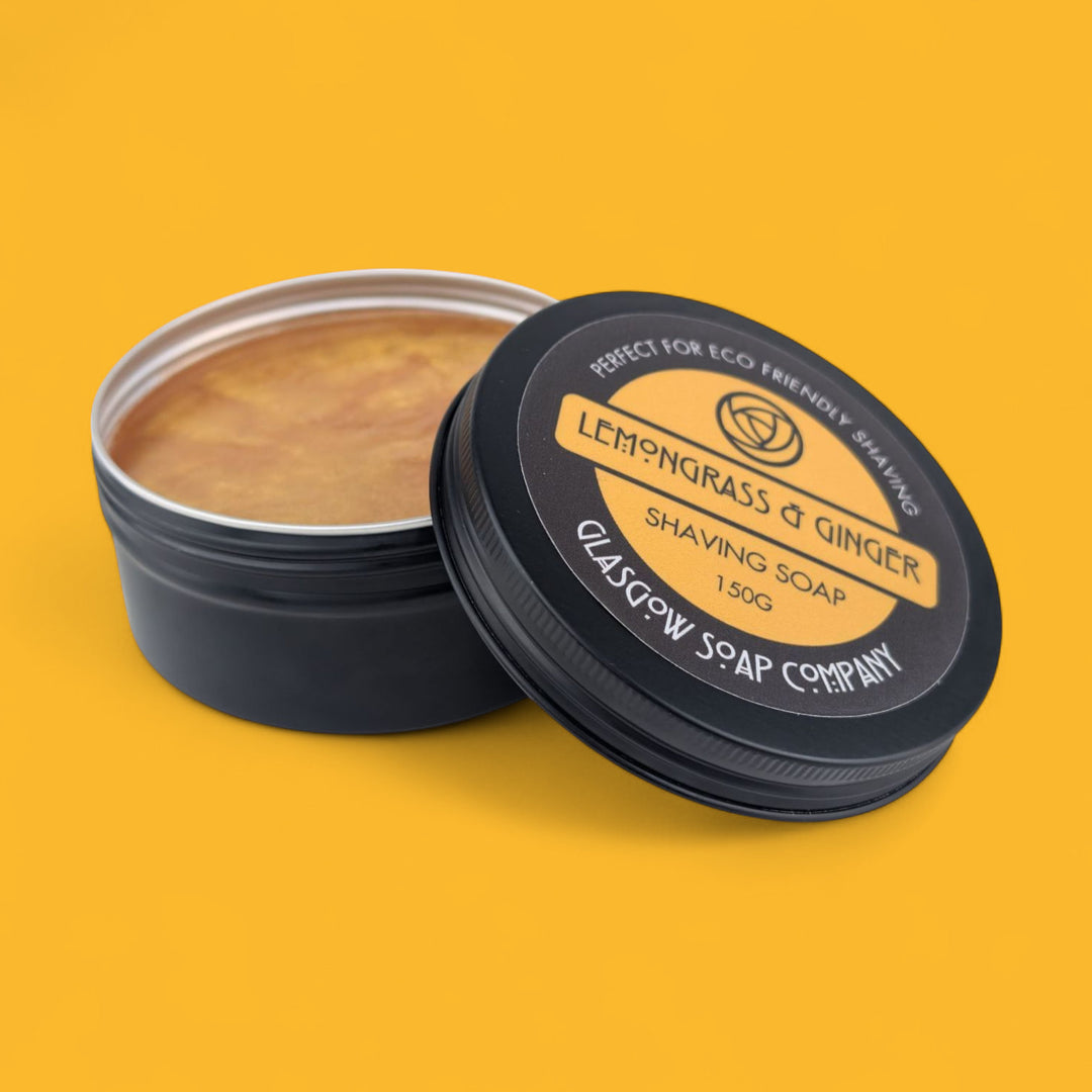 Shaving soap in a black container with 'Lemongrass & Ginger' label on a yellow background