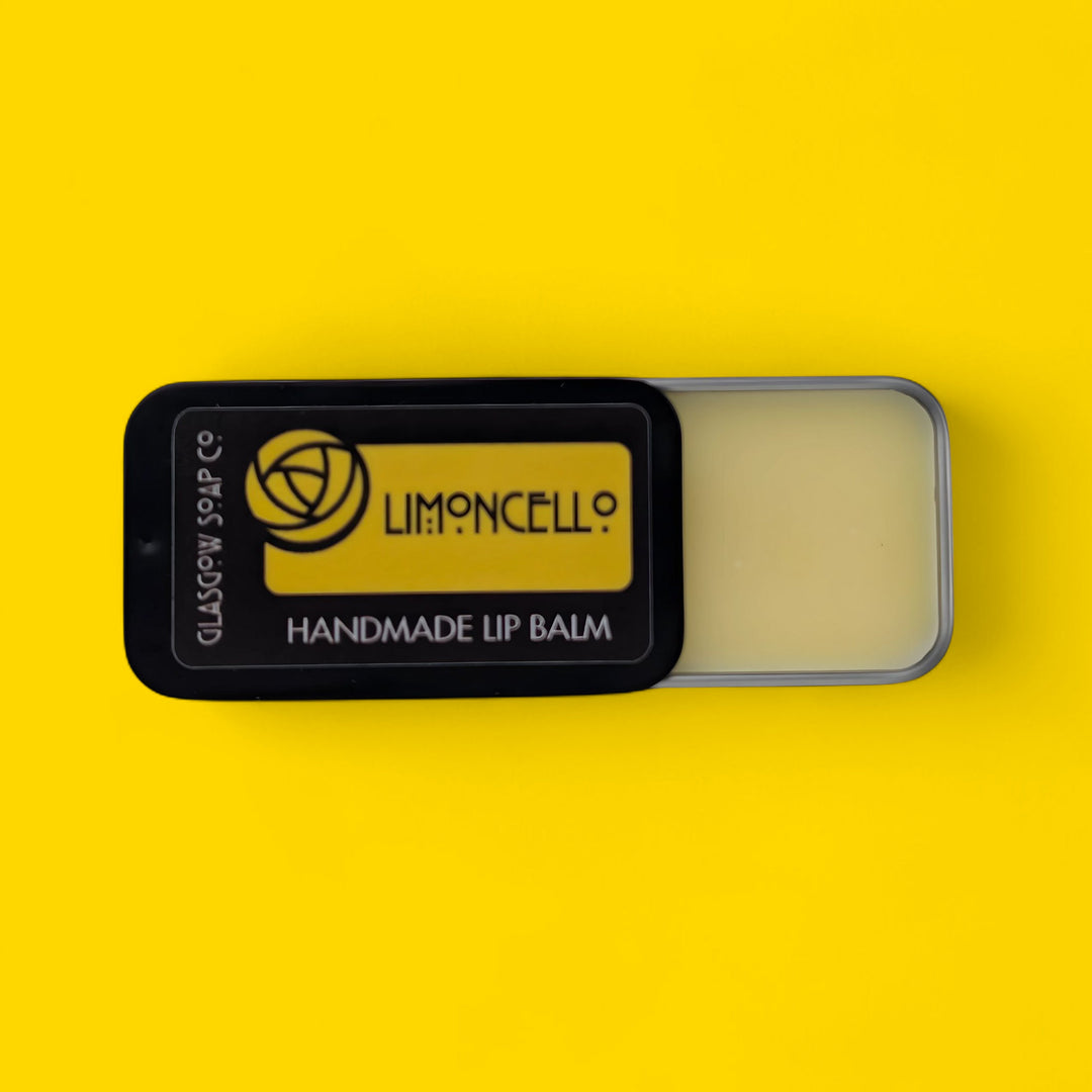Handmade lip balm in a black container with 'Limoncell?' branding on a yellow background