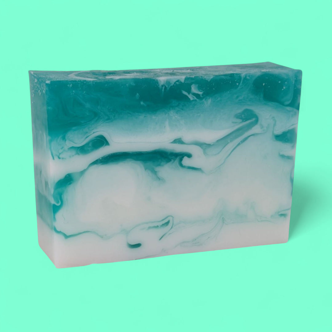 Marbled teal and white soap bar on a solid teal background