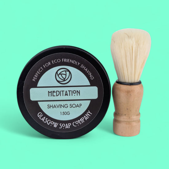 Shaving soap container and brush with 'Glasgow Soap Company' branding on a green background