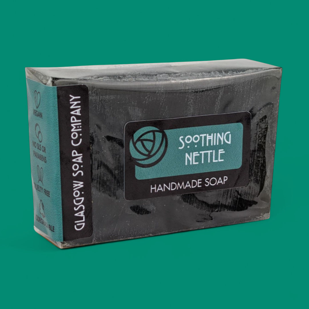 Handmade soap bar with 'Soothing Nettle' label on a green background