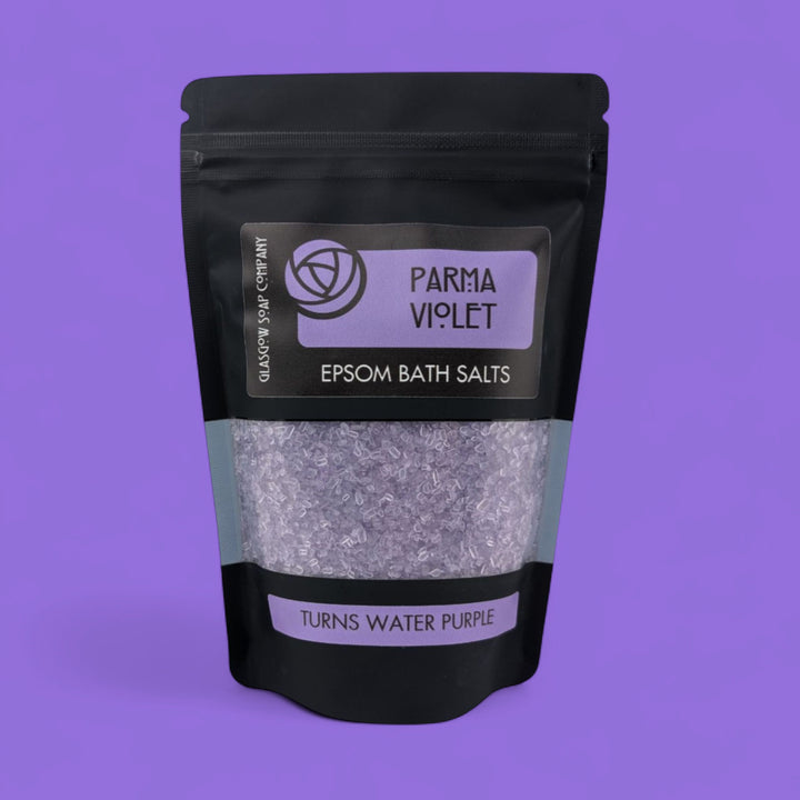 Pack of Epsom bath salts with 'Parma Violet' label on a purple background