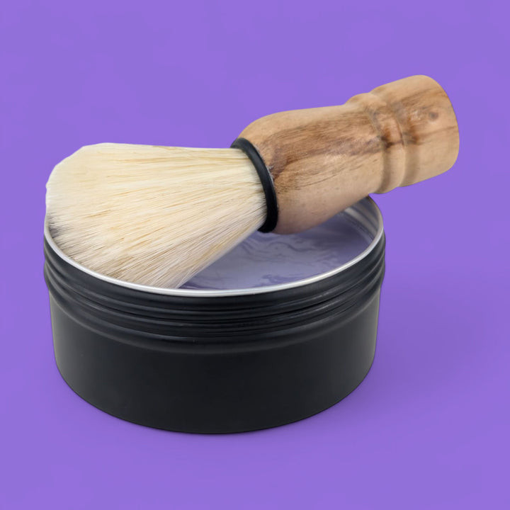 vegan Shaving brush with wooden handle and bristle head in a black container on a purple background