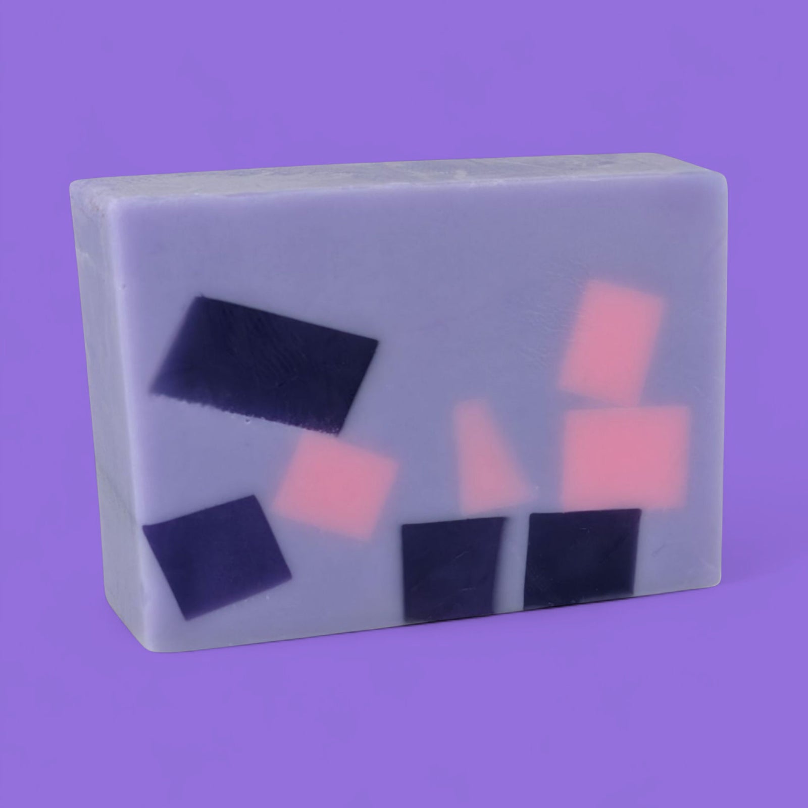 Bar of soap with pink and purple shapes on a purple background