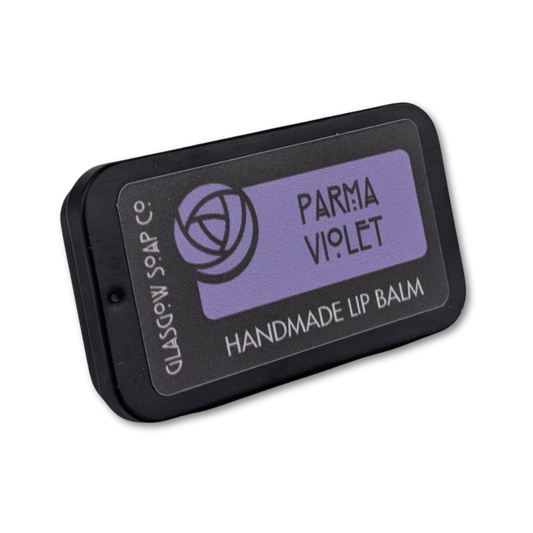 Handmade lip balm packaging with 'Parma Violet' label on a white background
