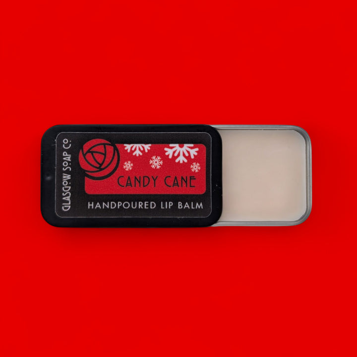Handpoured lip balm with 'Candy Cane' flavor on a red background
