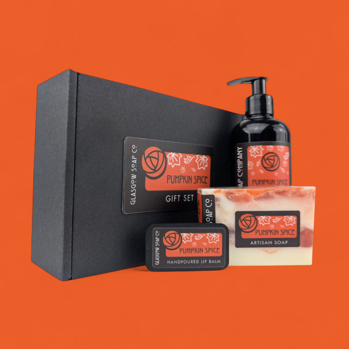 Pumpkin Spice gift set with soap, liquid soap, and lip balm on an orange background
