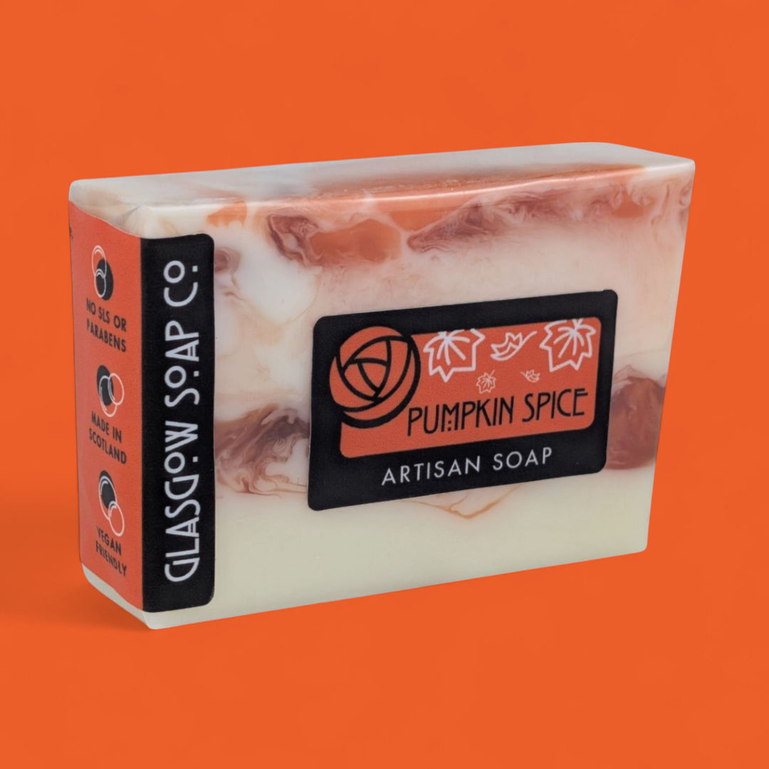 Marble-patterned pumpkin spice artisan soap with Glasgow Soap Co. branding on an orange background