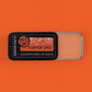 Pumpkin spice lip balm with a label on an orange background