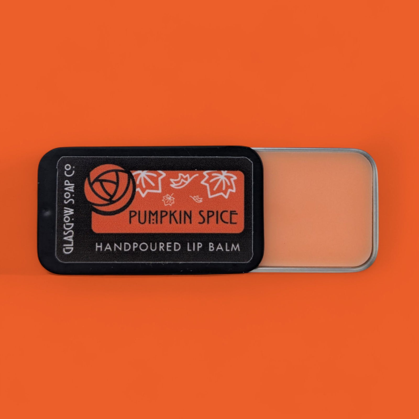 Pumpkin spice lip balm with a label on an orange background