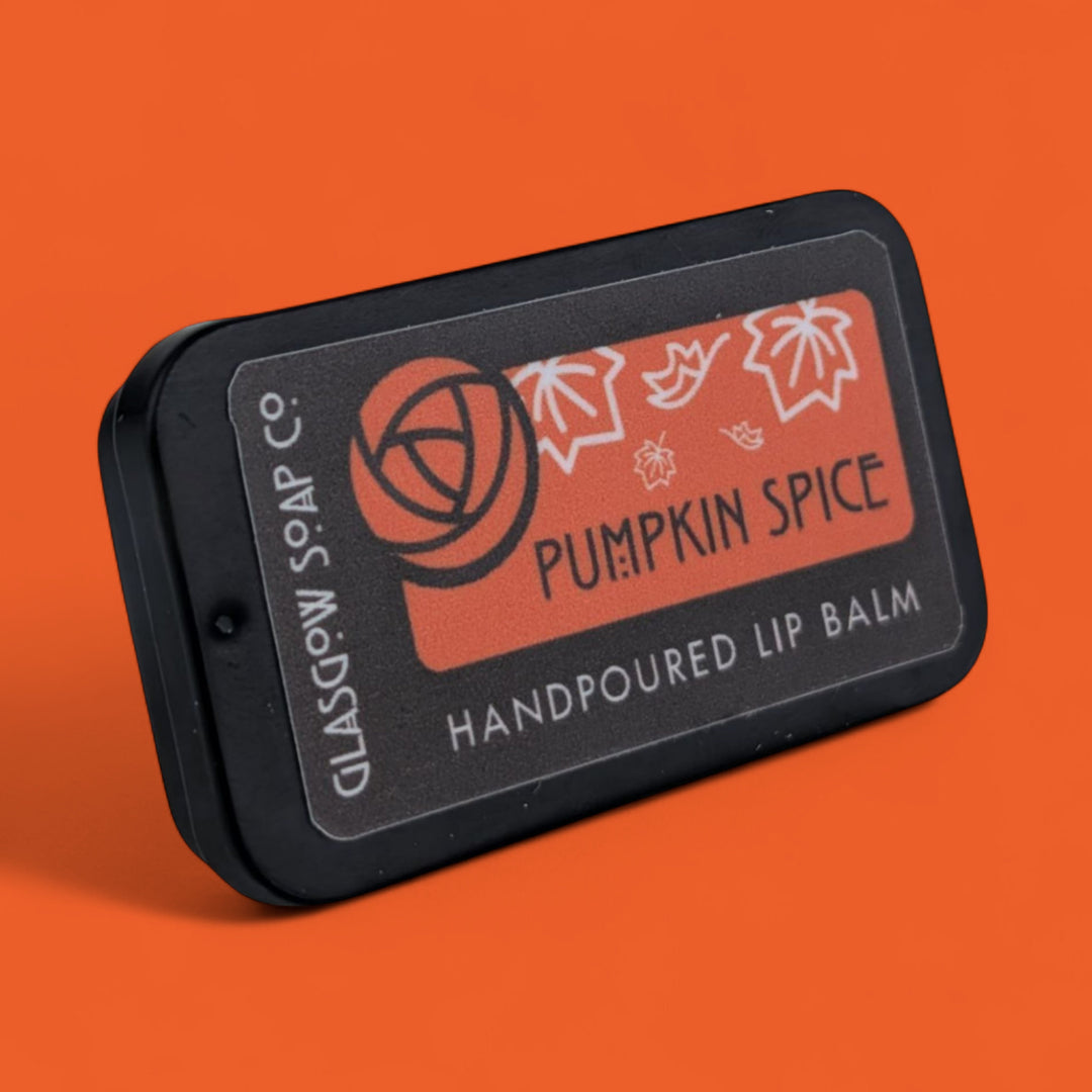 Lip balm packaging with 'Pumpkin Spice' label on an orange background