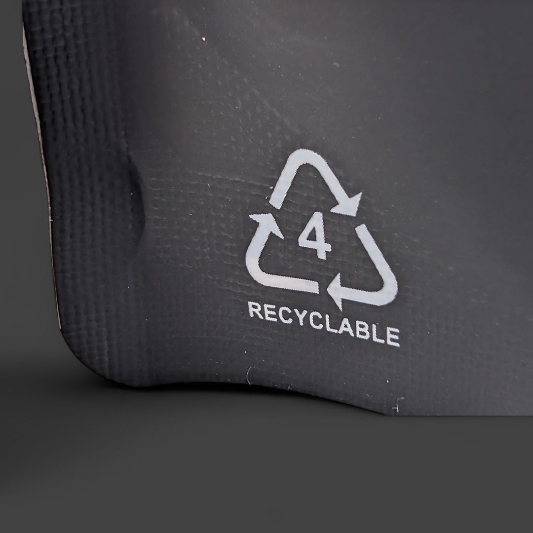 Recyclable symbol on a black surface