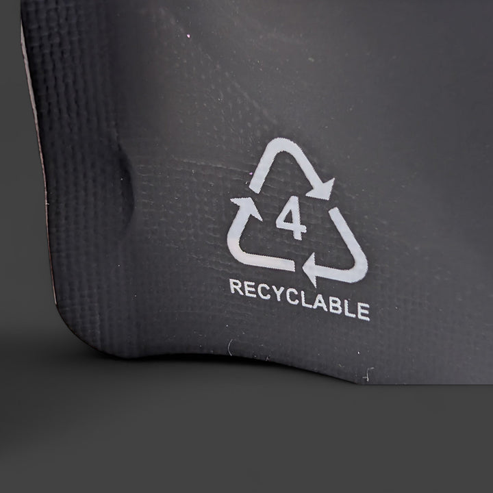 Recyclable symbol on a black surface