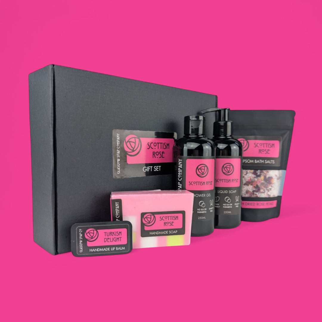Scottish Rose gift set with various products on a pink background