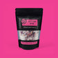 Scottish Rose Epsom Bath Salts packaging on a pink background