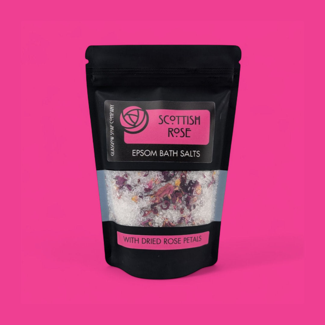 Scottish Rose Epsom Bath Salts packaging on a pink background