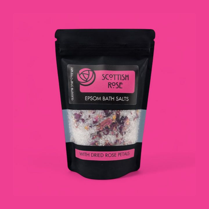 Scottish Rose Epsom Bath Salts packaging on a pink background
