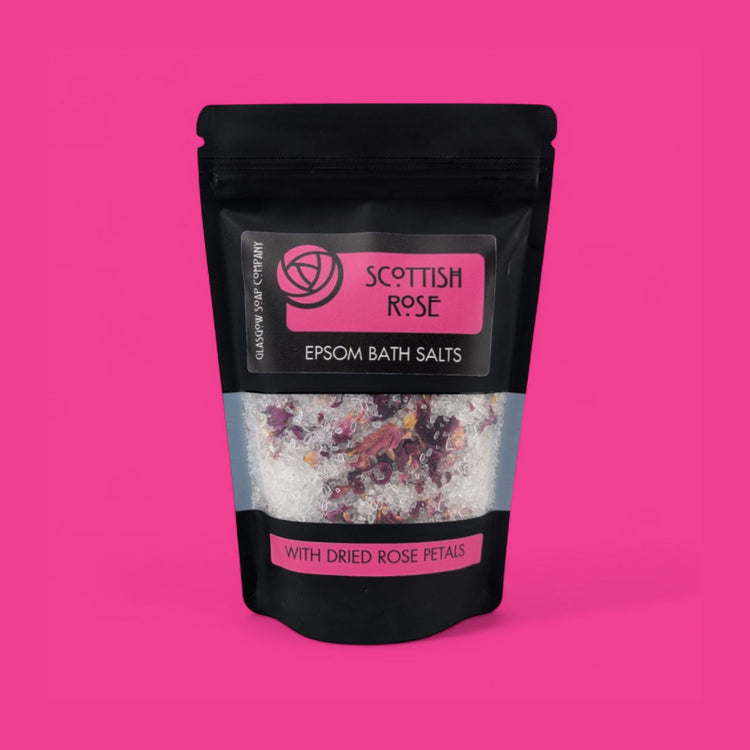 Scottish Rose Epsom Bath Salts packaging on a pink background
