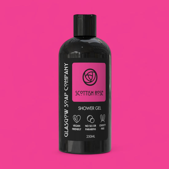 Black bottle of Glasgow Soap Company Scottish Rose Shower Gel on a pink background