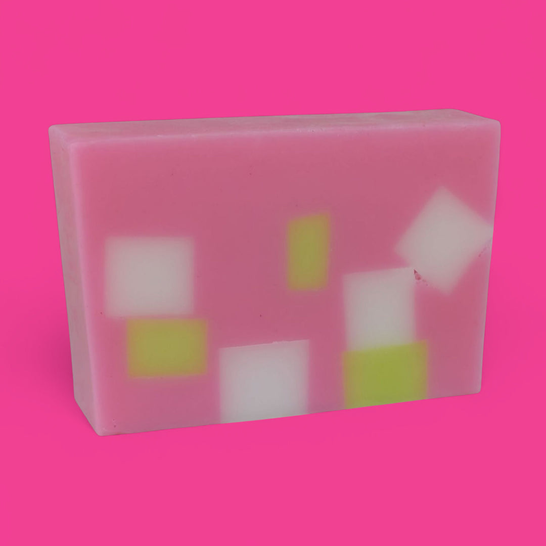 Rectangular soap with colorful square patterns on a pink background