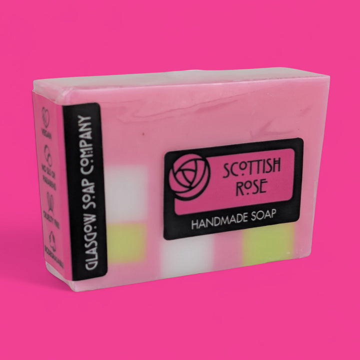 Handmade soap bar with 'Scottish Rose' label on a pink background