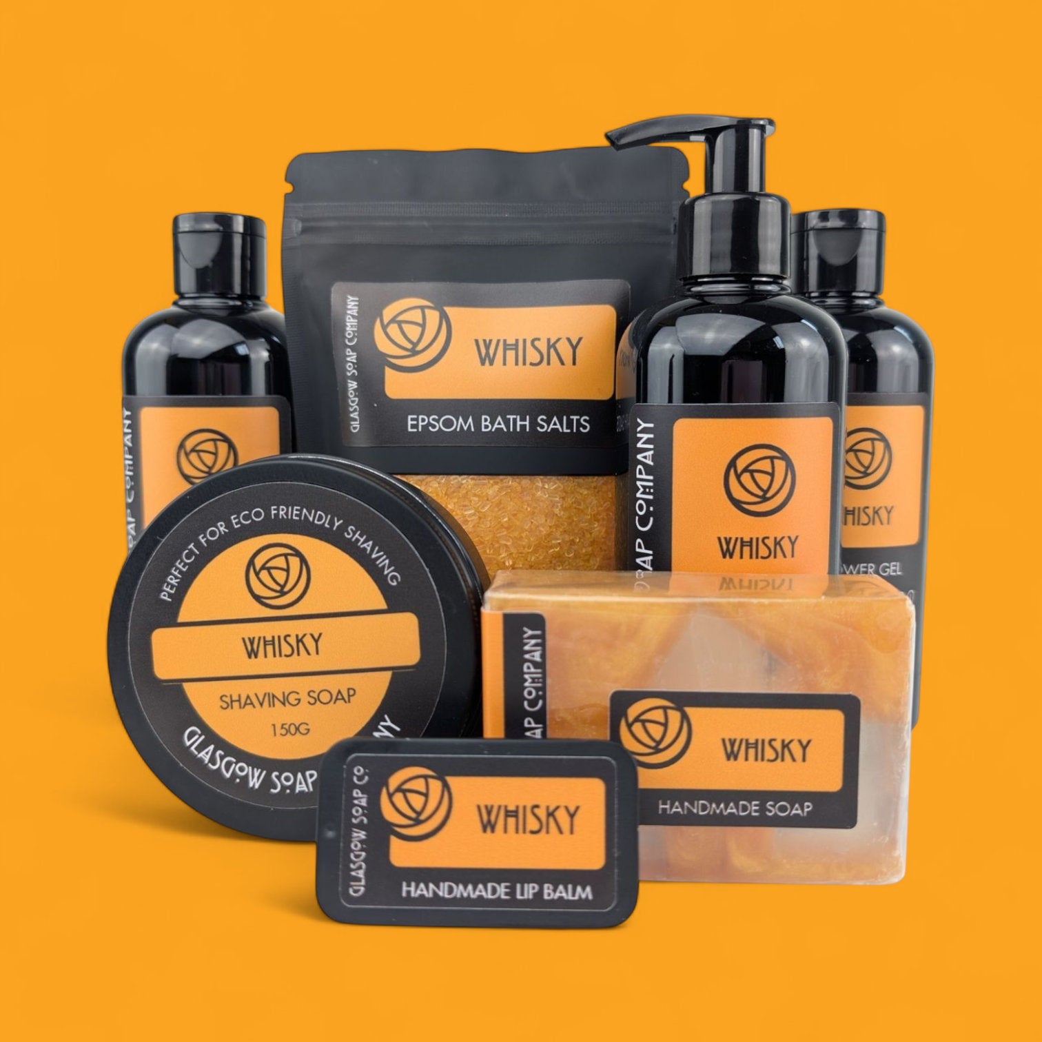 Collection of Whisky Glasgow Soap Company products on an orange background