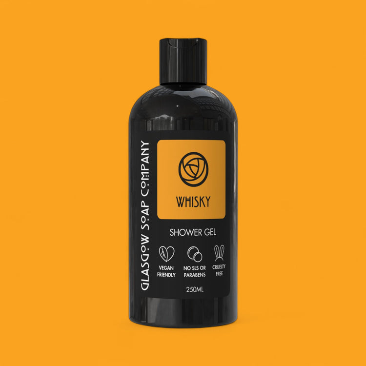 Black bottle of Glasgow Soap Company Whisky Shower Gel on an orange background