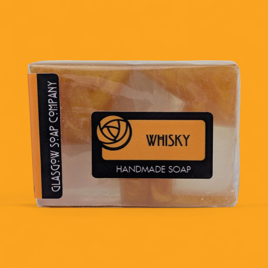Handmade soap bar with 'Whisky' label on an orange background