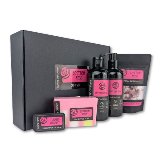 Scottish Rose gift set with various products including bottles, a bar of soap, and a pouch on a white background.
