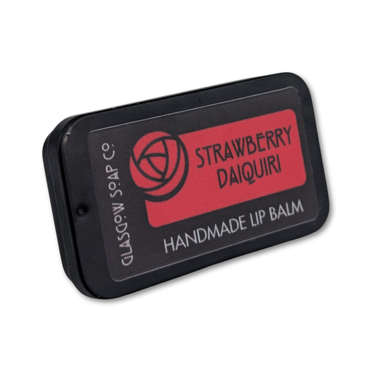 Handmade lip balm packaging with 'Strawberry Daiquiri' flavor on a white background