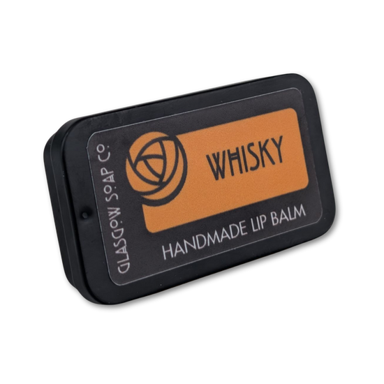 Handmade lip balm in a black tin labeled 'Whisky' on a white background