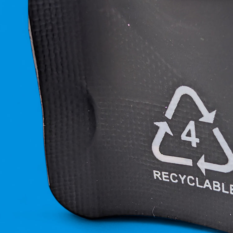 Recyclable symbol on a black surface with a blue background